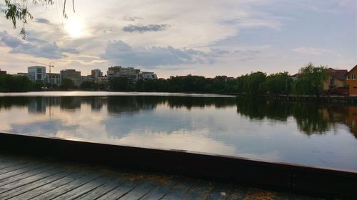 Scenic view of lake by buildings against sky