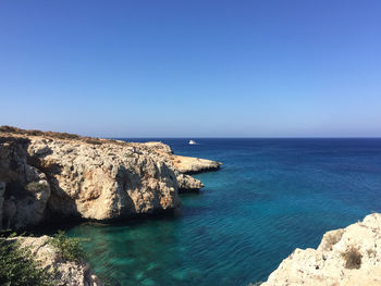 Scenic view of sea against clear blue sky
