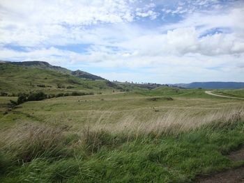 Countryside landscape against cloudy sky