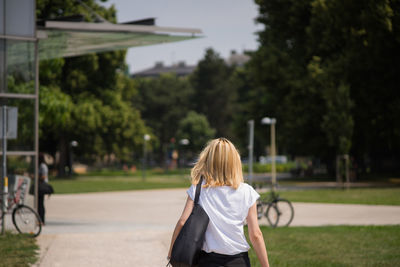 Rear view of woman against plants