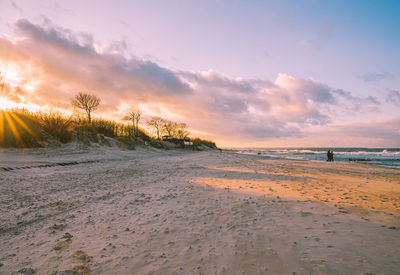 Scenic view of beach against sky during sunset