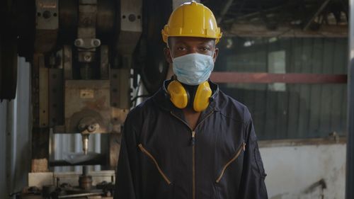 Portrait of manual worker wearing mask at factory