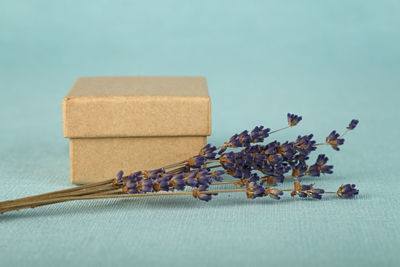 Close-up of lavenders by box on table