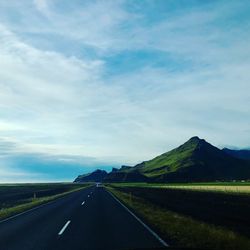 Empty road along countryside landscape