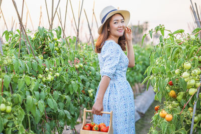 Young woman wearing hat against plants