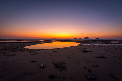 Scenic view of beach against sky during sunset