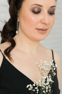 Close-up of young woman with bouquet