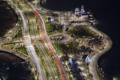 High angle view of illuminated light trails on highway at night