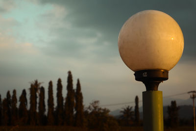 Low angle view of illuminated street light against sky