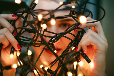 Close-up of hand holding illuminated lighting equipment