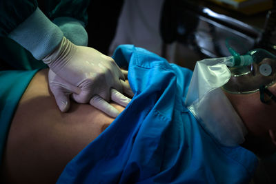 Low section of doctor examining patient in hospital