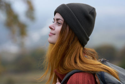 Portrait of young woman wearing beanie outdoors