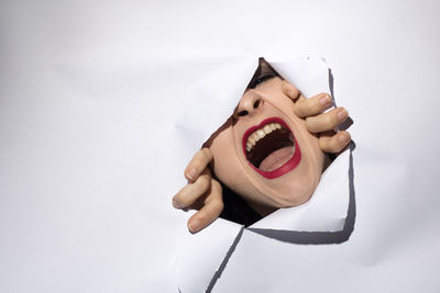 Close-up of woman hand against white background