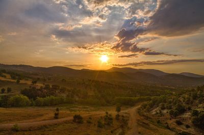 Scenic view of landscape against sky during sunset