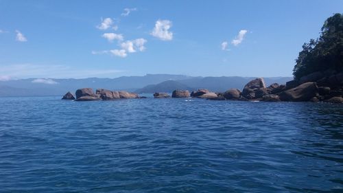 Scenic view of sea against blue sky