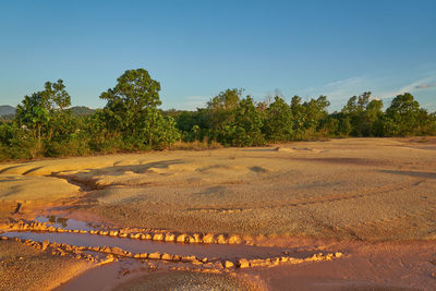 Scenic view of land against clear blue sky