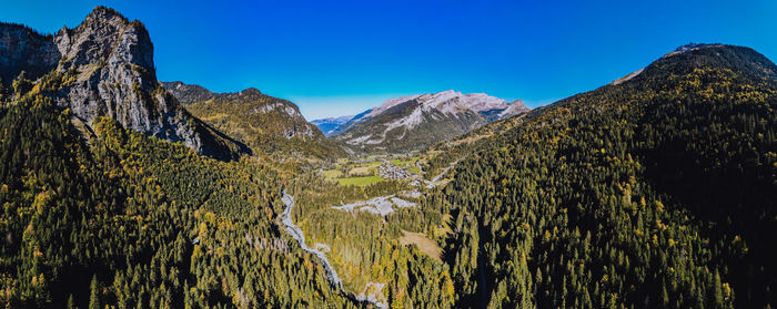 Scenic view of mountains against clear blue sky