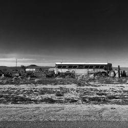 Abandoned truck on field against clear sky