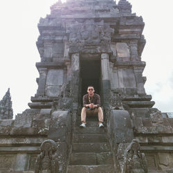 Low angle view of statue at temple against sky