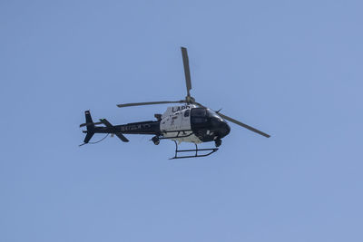 Low angle view of airplane against clear blue sky