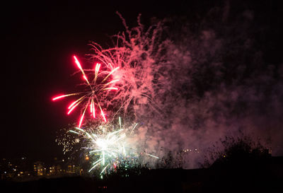 Low angle view of firework display at night