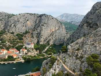 Scenic view of buildings and mountain against sky