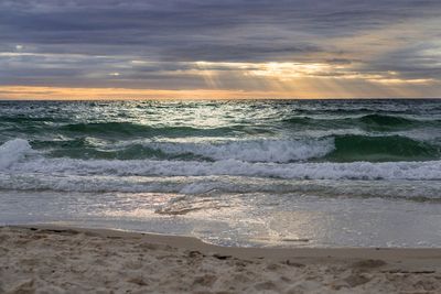 Scenic view of beach against sky during sunset