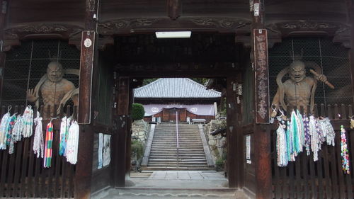 Low angle view of illuminated lanterns hanging by building