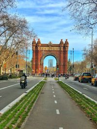 Road by monument against sky in city