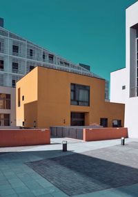 Modern buildings against clear blue sky