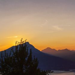 Scenic view of silhouette mountains against sky during sunset