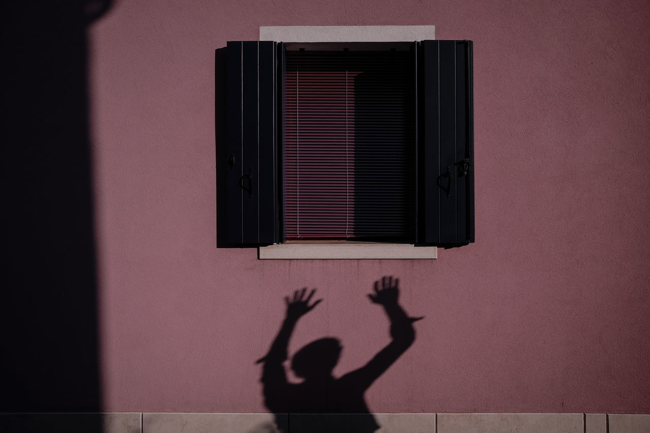 SHADOW OF MAN AND WOMAN ON WALL