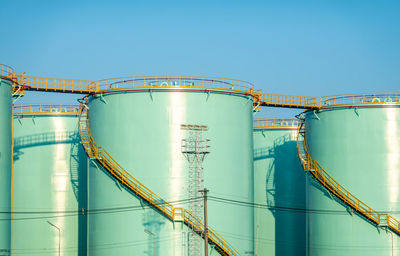 Low angle view of crane against clear blue sky