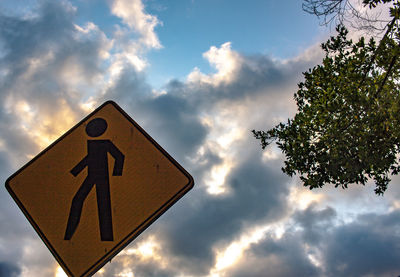 Low angle view of road sign against sky