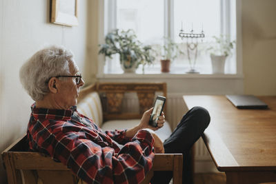 Senior man talking to woman via video call