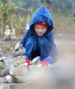 Cute boy stacking rocks