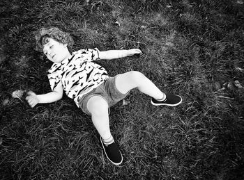 High angle view of child lying on land