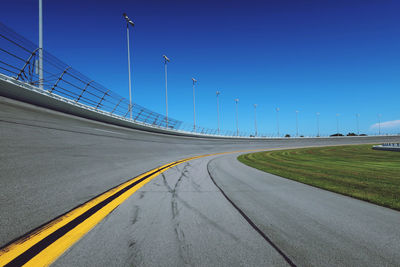 Empty sports track against blue sky