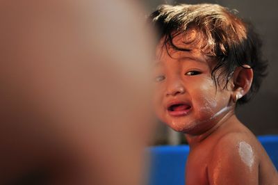 Cute girl crying during bathing