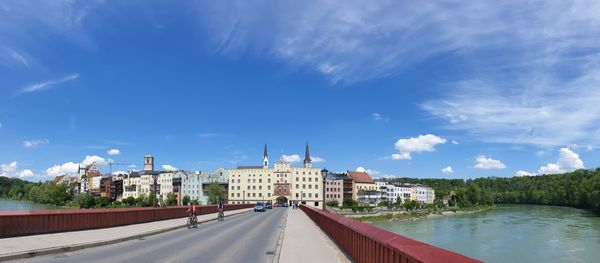 View of buildings in city against cloudy sky