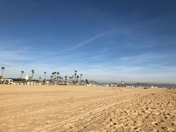 Scenic view of beach against blue sky