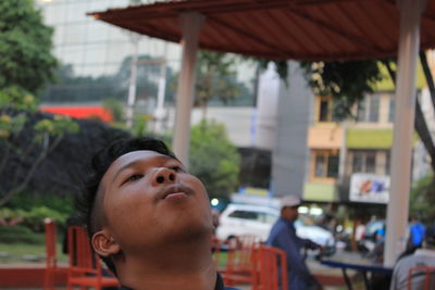 Close-up of man exhaling smoke at cafe