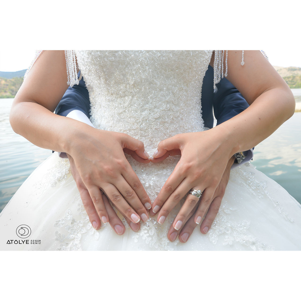 MIDSECTION OF WOMAN MAKING HEART SHAPE WITH WATER