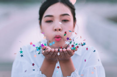 Close-up of young woman with flowers