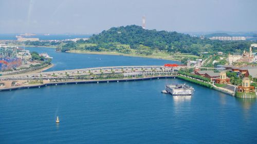 Scenic view of sea and city against sky