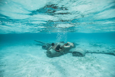 Full length of man swimming undersea