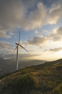 Windmill on field against sky