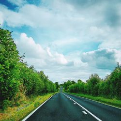 Scenic view of road against cloudy sky