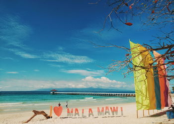 Scenic view of beach against blue sky