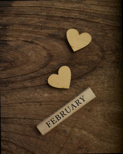Directly above shot of text on heart shape wood